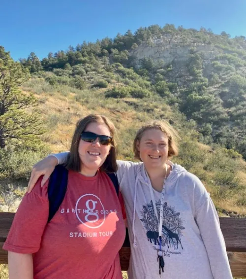 Two Students pose for a photo while hiking