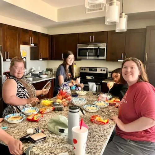 OIS Students make a meal in their apartment